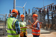 © Trevor Adeline/Caia Image - Engineers with digital tablet at sunny power plant