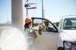 © Trevor Adeline/Caia Image - Workers talking at truck at power plant