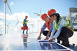 © Trevor Adeline/Caia Image - Engineers reviewing blueprints at solar panel at power plant