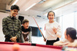 © Sam Edwards/Caia Image - Happy teenagers playing pool in community center