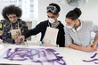 © Sam Edwards/Caia Image - Teenage boys spray painting in high school art class