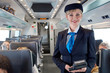 © Rafal Rodzoch/Caia Image - Portrait confident female attendant on passenger train