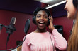 © Sam Edwards/Caia Image - Teenage girl musicians recording music, singing in sound booth