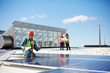 © Trevor Adeline/Caia Image - Engineer testing solar panels at sunny power plant