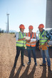 © Trevor Adeline/Caia Image - Engineer and workers using digital tablet at wind turbine power plant