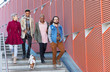 © Chris Ryan/Caia Image - Young friends walking down down urban, modern stairs