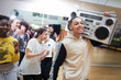 © Sam Edwards/Caia Image - Enthusiastic, cool teenage boy with boom box in dance class studio