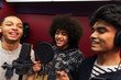 © Sam Edwards/Caia Image - Teenage musicians recording music, singing in sound booth
