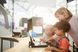 © Trevor Adeline/Caia Image - Teacher and schoolgirls using laptop in science center