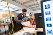 © Chris Ryan/Caia Image - Creative business people discussing paperwork in office