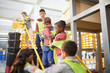 © Trevor Adeline/Caia Image - Kids playing toy bricks at interactive construction exhibit in science center