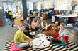 © Chris Ryan/Caia Image - Portrait confident creative business team meeting, brainstorming in circle on office floor