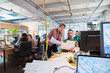 © Chris Ryan/Caia Image - Creative business people discussing paperwork in open plan office