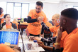 © Sam Edwards/Caia Image - Hackers handshaking, celebrating and coding for charity at hackathon