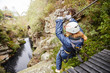 © Trevor Adeline/Caia Image - Woman zip lining over pond in woods