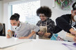 © Sam Edwards/Caia Image - High school boys spray painting in art class