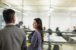 © Martin Barraud/Caia Image - Businesswoman walking and talking with colleague in office