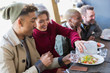 © Chris Ryan/Caia Image - Smiling young couple dining at restaurant outdoor cafe