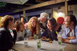 © Trevor Adeline/Caia Image - Friends hanging out, drinking on patio at night