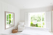 © Charlie Dean/Caia Image - White, tranquil home showcase bedroom open to sunny patio with hammock