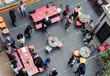 © Sam Edwards/Caia Image - Overhead view friends socializing, drinking eating at party on patio