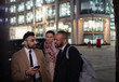 © Paul Bradbury/Caia Image - Business people with smart phone talking on city street at night