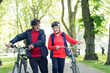 © Robert Daly/Caia Image - Active senior couple walking bikes in park