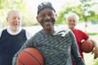 © Tom Merton/Caia Image - Portrait confident, smiling active senior men friends basketballs in park