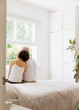 © Tom Merton/Caia Image - Serene senior couple sitting on bed and looking out window