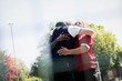 © Tom Merton/Caia Image - Active senior men friends hugging in sunny park