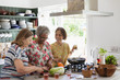 © Tom Merton/Caia Image - Active senior women cooking in kitchen