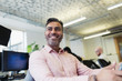© Sam Edwards/Caia Image - Smiling, confident businessman working in office