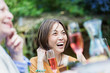 © Tom Merton/Caia Image - Laughing senior woman enjoying garden party