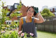 Portrait Smiling Woman Gardening In Sunny Yard
