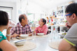 © Sam Edwards/Caia Image - Multi-generation family eating noodles with chopsticks at table