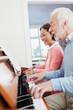 © Robert Daly/Caia Image - Active senior couple playing piano