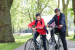 © Robert Daly/Caia Image - Portrait smiling, confident active senior couple riding bikes in park