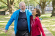 © Robert Daly/Caia Image - Affectionate active senior couple walking in park