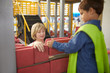 © Trevor Adeline/Caia Image - Teacher schoolboy stacking bricks at interactive construction exhibit in science center