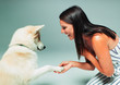 © Paul Bradbury/Caia Image - Smiling woman shaking dogs paw