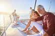 © Trevor Adeline/Caia Image - Friends relaxing on sunny catamaran