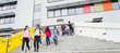 © Robert Daly/Caia Image - Junior high students leaving school building, descending steps