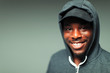 © Paul Bradbury/Caia Image - Portrait smiling, confident teenage boy in hoody