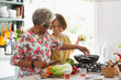 © Tom Merton/Caia Image - Active senior women cooking in kitchen