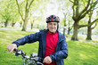 © Tom Merton/Caia Image - Portrait confident active senior man riding bike in park