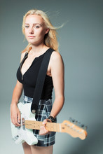 Portrait Confident, Cool Young Woman Playing Electric Guitar