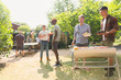 © Tom Merton/Caia Image - Male friends barbecuing in sunny summer backyard
