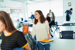 © Paul Bradbury/Caia Image - Smiling high school girl student leaving classroom