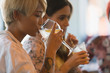 © Tom Merton/Caia Image - Young woman drinking cocktail in bar