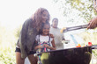 © Sam Edwards/Caia Image - Happy sisters enjoying barbecue at campsite